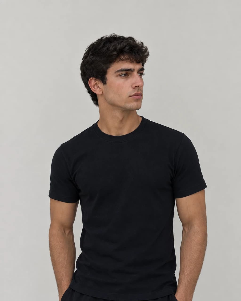 BASEFIT Essential T-Shirt in black, worn to show the regular fit through the chest and body